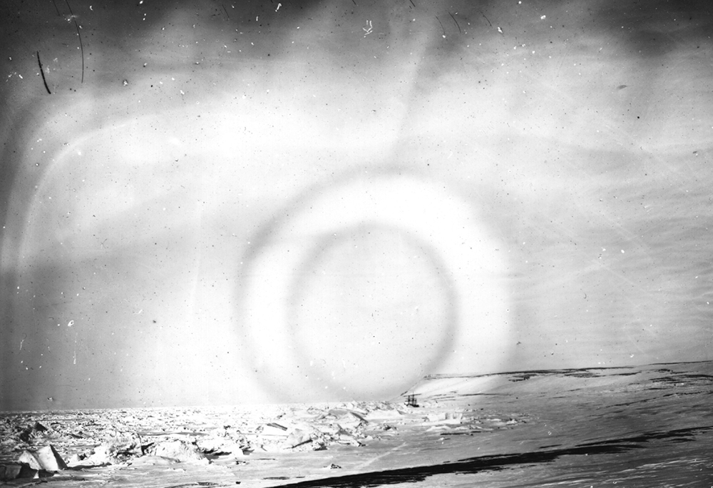 The Aurora Borealis, a luminous phenomenon, otherwise called the 'Northern Lights' is viewed over the Arctic, photographed by members of the British Nares expedition. Their ship can be seen trapped in sea ice in the bay. (Photo by Hulton Archive/Getty Images)