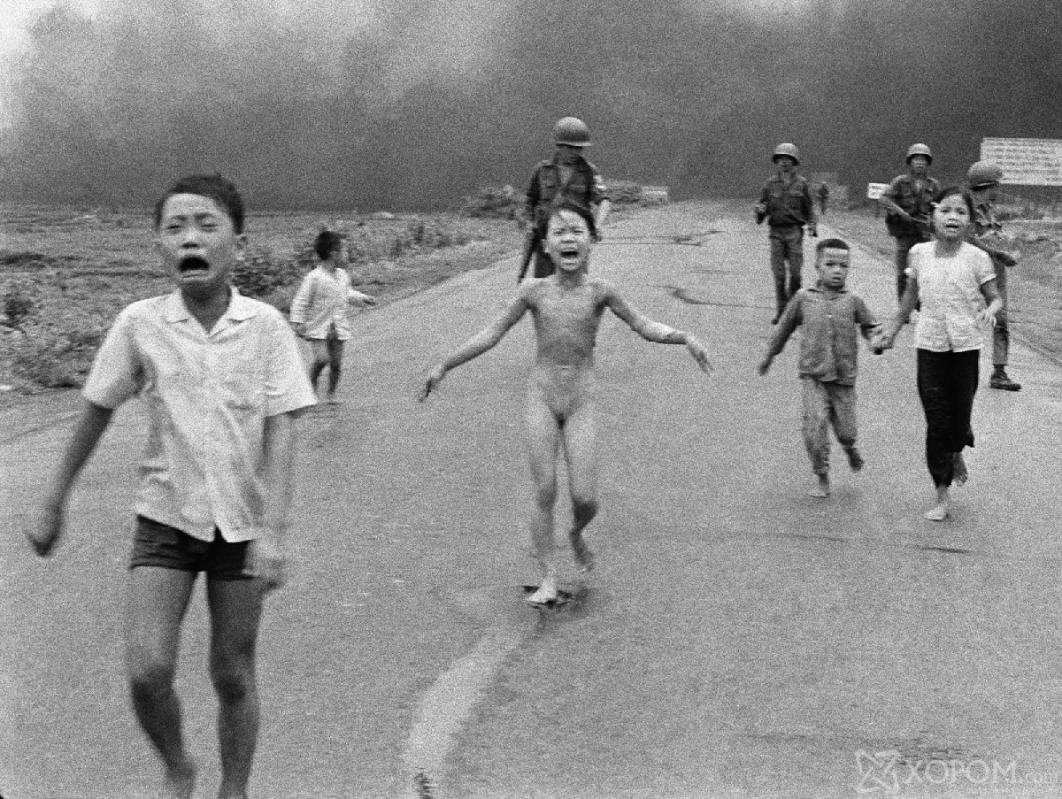 In this June 8, 1972 file photo, crying children, including 9-year-old Kim Phuc, center, run down Route 1 near Trang Bang, Vietnam after an aerial napalm attack on suspected Viet Cong hiding places as South Vietnamese forces from the 25th Division walk behind them. A South Vietnamese plane accidentally dropped its flaming napalm on South Vietnamese troops and civilians. From left, the children are Phan Thanh Tam, younger brother of Kim Phuc, who lost an eye, Phan Thanh Phouc, youngest brother of Kim Phuc, Kim Phuc, and Kim's cousins Ho Van Bon, and Ho Thi Ting. (AP Photo/Nick Ut, File)