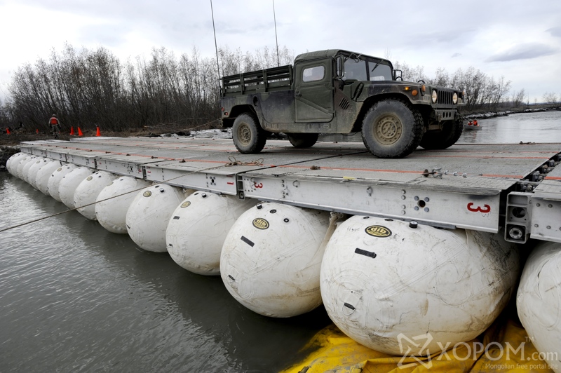 A Humvee from the 84th Engineer Support Company, 6th Engineering Battalion, is one of the first vehicles to cross the Lightweight Modular Causeway System during testing at Fort Richardson, Alaska, April 28. The LMCS is a hybrid fixed bridging system and floating causeway system. Originally designed for vessel-to-shore bridging applications, it has proven ideally suited for wet-gap crossing solutions. The load capacity is 70 tons. Here it is being used to respond during Arctic Edge 2010 as an earthquake recovery tool. (U.S. Air Force photo/Staff Sgt. Brian Ferguson)