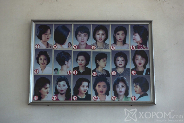 Photos showing example hair styles hang inside a hair salon in Pyongyang, North Korea on Wednesday, Feb. 20, 2013. (AP Photo/David Guttenfelder)