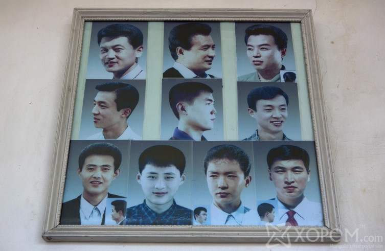 Photos showing example hair styles hang inside a barber shop in Pyongyang, North Korea on Wednesday, Feb. 20, 2013. (AP Photo/David Guttenfelder)