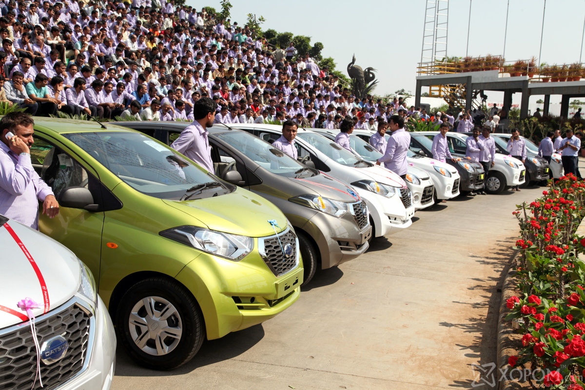 PIC FROM CATERS NEWS - (PICTURED: Employees gather around some of the cars that were given out as gifts.) - An altruistic boss generosity for doling out expensive gifts to his staff has taken everyone by surprise in India. Savjibhai Dholakia, 54, has rewarded at least 1,665 of his hardworking employees with cars, apartments and money as a Diwali gift. Diwali, also known as the festival of lights, is the biggest Hindu festival celebrated in autumn every year. SEE CATERS COPY.
